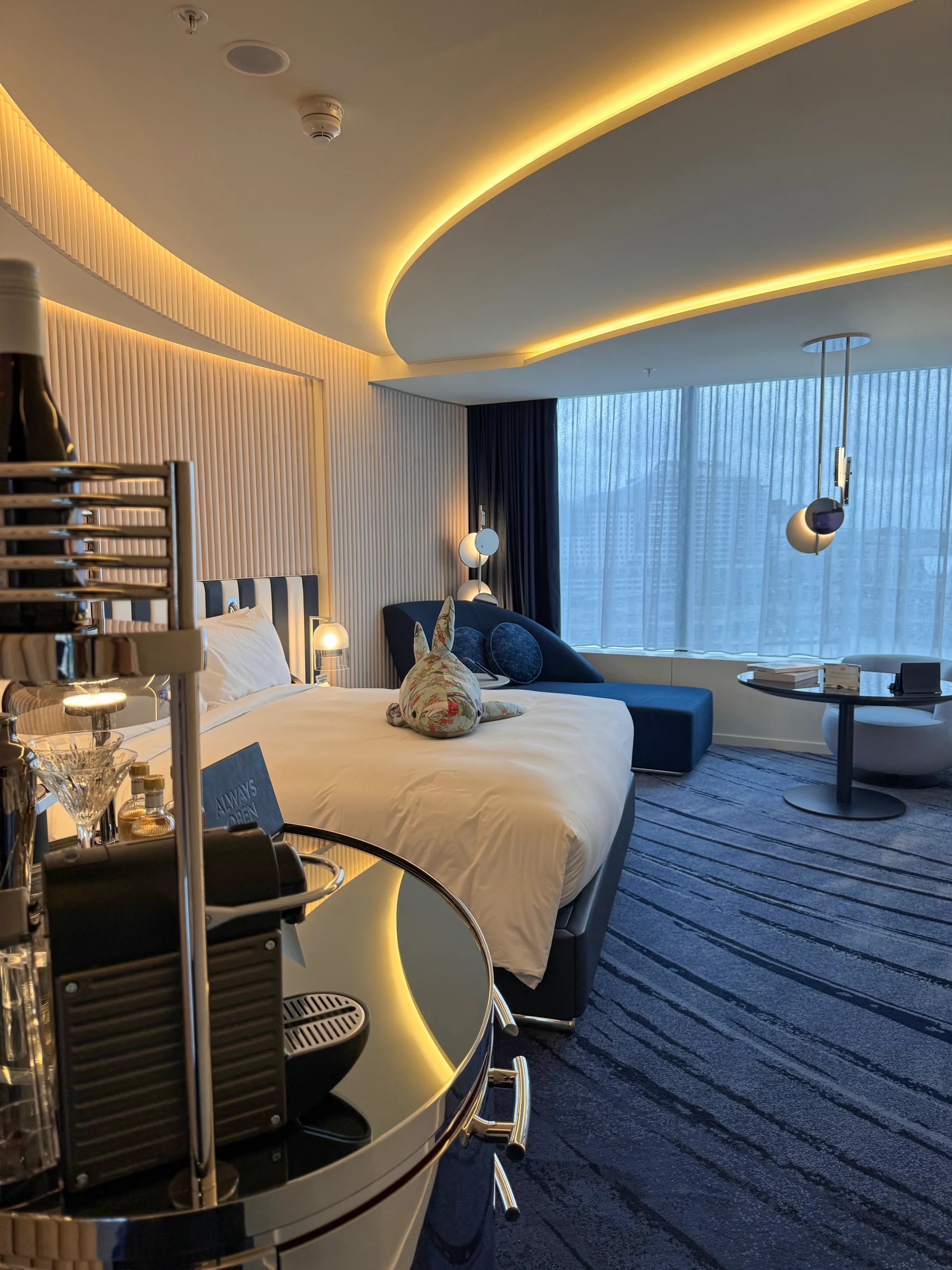 The room with its blue sofa and curved lighting.