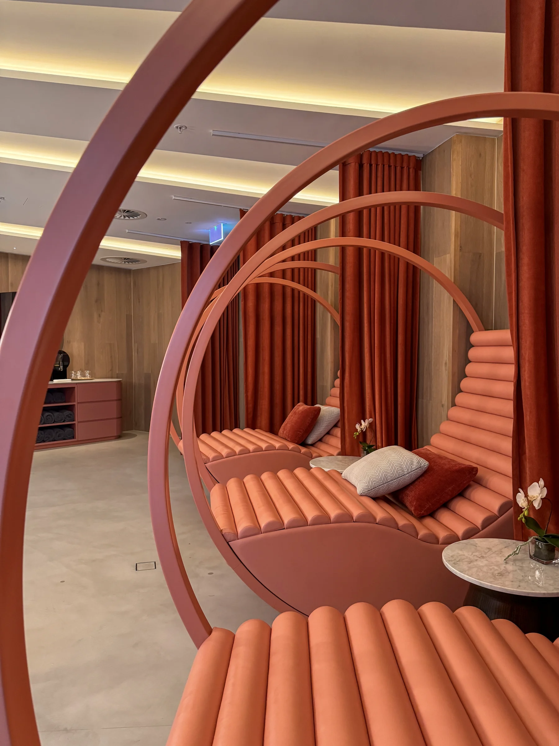 Spa lounge chairs with overlapping red curves.
