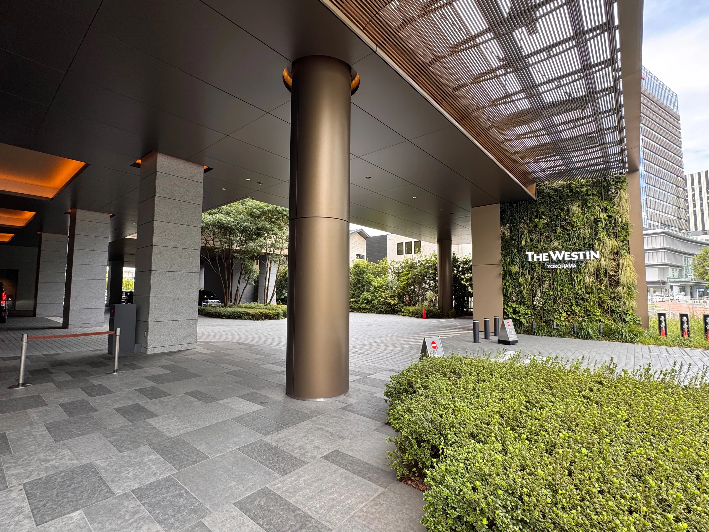 The hotel entrance surrounded by greenery