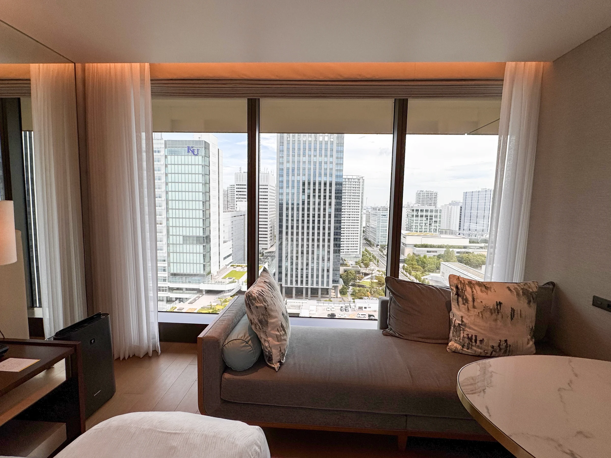 A long sofa by the window overlooking the city